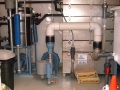 Low profile air stripper to remove dissolved contaminants in groundwater