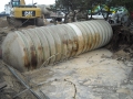 Fiberglass underground storage tank being removed from service